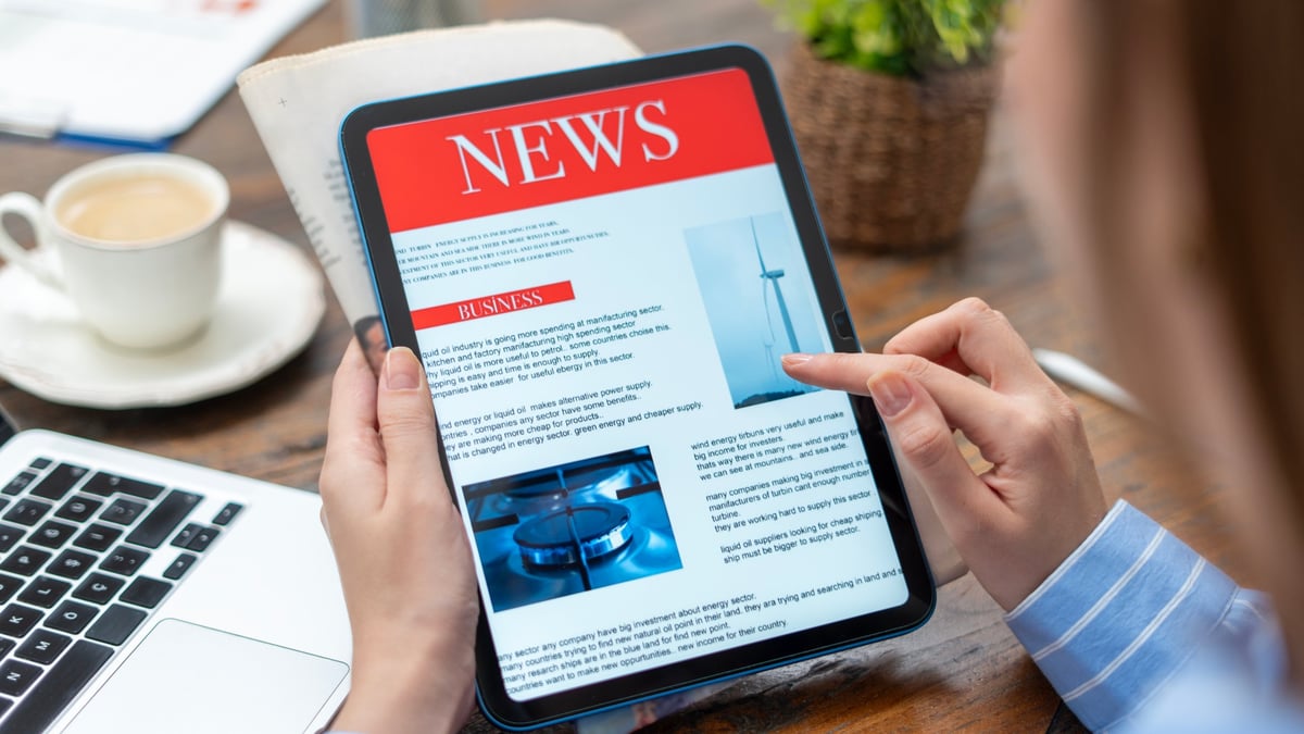 Business woman using tablet pc for reading news